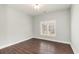 This bedroom includes hardwood floors, white baseboards, one window with shutters and a ceiling light fixture at 1435 Saint Thomas Circle # E-1, Myrtle Beach, SC 29577