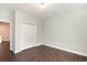 This bedroom includes hardwood floors, white baseboards, closet with doors and a ceiling light fixture at 1435 Saint Thomas Circle # E-1, Myrtle Beach, SC 29577