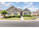 Charming one-story home featuring well-manicured landscaping and traditional architectural details at 1435 Saint Thomas Circle # E-1, Myrtle Beach, SC 29577