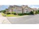 Beautiful tan home exterior featuring meticulously maintained landscaping and lovely window design at 1435 Saint Thomas Circle # E-1, Myrtle Beach, SC 29577