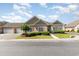 Attractive home featuring an attached two-car garage and well-maintained front yard at 1435 Saint Thomas Circle # E-1, Myrtle Beach, SC 29577