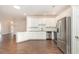 Modern white kitchen featuring stainless steel appliances, granite countertops, and ample cabinet space at 1435 Saint Thomas Circle # E-1, Myrtle Beach, SC 29577