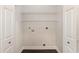 Functional laundry room with hookups and shelving ready for appliances at 1435 Saint Thomas Circle # E-1, Myrtle Beach, SC 29577