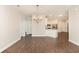 Open-concept living and dining area with a chandelier, laminate flooring, and access to the kitchen at 1435 Saint Thomas Circle # E-1, Myrtle Beach, SC 29577