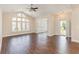 Bright living room boasts gorgeous laminate flooring and a large arched window for natural light at 1435 Saint Thomas Circle # E-1, Myrtle Beach, SC 29577