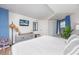 Bedroom featuring a large bed, flatscreen TV, a plant near the window, and stylish furnishings at 1501 S Ocean Blvd. # 1250, Myrtle Beach, SC 29577