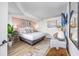 Cozy bedroom featuring a large bed, a plant, stylish lamps, and colorful floor decor at 1501 S Ocean Blvd. # 1250, Myrtle Beach, SC 29577