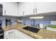 Bright kitchen features granite countertops, stainless sink and a coffee maker at 1501 S Ocean Blvd. # 1250, Myrtle Beach, SC 29577