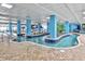 Lazy river area with shallow water, blue pillars, and tropical plants at 1501 S Ocean Blvd. # 1250, Myrtle Beach, SC 29577