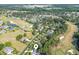 Scenic aerial view of the neighborhood showcasing the golf course, ponds, and well-manicured lawns at 154 Windsor Circle Sw, Ocean Isle Beach, NC 28469