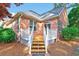 Back of house featuring a brick exterior, a wooden deck and mature trees at 154 Windsor Circle Sw, Ocean Isle Beach, NC 28469
