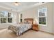 Cozy bedroom with natural light, a ceiling fan, and a comfortable bed at 154 Windsor Circle Sw, Ocean Isle Beach, NC 28469