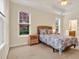 Serene bedroom features multiple windows, a ceiling fan, and a wicker bedframe at 154 Windsor Circle Sw, Ocean Isle Beach, NC 28469