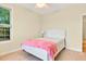 Inviting bedroom with hardwood floors, a ceiling fan, and large window allowing ample natural light at 154 Windsor Circle Sw, Ocean Isle Beach, NC 28469