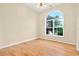 Sunny bedroom with hardwood floors and an arched window offering a pleasant view at 154 Windsor Circle Sw, Ocean Isle Beach, NC 28469