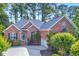 Charming brick home with mature landscaping, a well-manicured lawn, and an attached two car garage at 154 Windsor Circle Sw, Ocean Isle Beach, NC 28469
