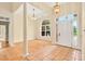 Inviting foyer with hardwood floors, arched window, tiled entrance, and a beautiful front door at 154 Windsor Circle Sw, Ocean Isle Beach, NC 28469