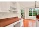 Well-lit kitchen featuring tiled floors, white cabinetry, and views to the living room at 154 Windsor Circle Sw, Ocean Isle Beach, NC 28469