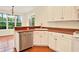 Kitchen with white cabinetry, stainless steel appliances, and tiled flooring at 154 Windsor Circle Sw, Ocean Isle Beach, NC 28469