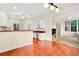 Open concept kitchen with white cabinetry and view of bright living room at 154 Windsor Circle Sw, Ocean Isle Beach, NC 28469
