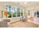 Bright living room features a neutral color scheme, large windows, and hardwood flooring at 154 Windsor Circle Sw, Ocean Isle Beach, NC 28469