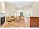 Cozy living room with a fireplace, comfortable seating, and a view of the entrance foyer at 154 Windsor Circle Sw, Ocean Isle Beach, NC 28469