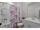 Bathroom featuring shower/tub combo with floral curtain, white vanity and a modern sink at 155 S Reindeer Rd., Surfside Beach, SC 29575