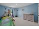 A charming ' bedroom with blue walls, a play tent and a wooden changing table at 155 S Reindeer Rd., Surfside Beach, SC 29575