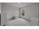 A simple bedroom featuring a window view, carpet flooring, and neutral wall color at 155 S Reindeer Rd., Surfside Beach, SC 29575