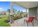Inviting front porch featuring stone accents and red chairs offers a relaxing outdoor space at 155 S Reindeer Rd., Surfside Beach, SC 29575