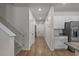 Inviting hallway with wood floors leads to a modern kitchen and stairs to the upper level at 155 S Reindeer Rd., Surfside Beach, SC 29575