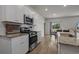 Well-lit kitchen featuring granite counters, stainless steel appliances, and white cabinetry at 155 S Reindeer Rd., Surfside Beach, SC 29575
