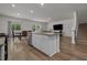 Well-lit kitchen featuring an island with seating, opening to dining and living spaces at 155 S Reindeer Rd., Surfside Beach, SC 29575