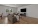 Comfortable living room features plush sofas and entertainment center beneath a large window at 155 S Reindeer Rd., Surfside Beach, SC 29575