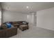 An open living room with a large sectional sofa, carpet flooring and neutral walls at 155 S Reindeer Rd., Surfside Beach, SC 29575
