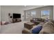 Spacious carpeted living room with a large sectional sofa and a TV on a media console at 155 S Reindeer Rd., Surfside Beach, SC 29575