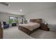 Spacious main bedroom with large window, ensuite, and neutral decor at 155 S Reindeer Rd., Surfside Beach, SC 29575