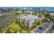 An aerial daytime view showcasing a multi-story apartment complex surrounded by lush landscaping and paved parking at 1582 S Waccamaw Dr. # 34, Garden City Beach, SC 29576