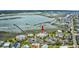 Aerial view showing a multi-story apartment complex next to a body of water with an adjacent parking lot at 1582 S Waccamaw Dr. # 34, Garden City Beach, SC 29576