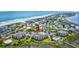 Aerial view of a neighborhood near a beach, featuring multi-story apartments, lush lawns, and a community pool at 1582 S Waccamaw Dr. # 34, Garden City Beach, SC 29576