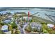 Aerial view of a multi-story apartment complex with palm trees and a parking lot, with a water view in the background at 1582 S Waccamaw Dr. # 34, Garden City Beach, SC 29576