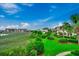 A lovely backyard view with lush greenery, colorful flowers, and waterfront buildings at 1582 S Waccamaw Dr. # 34, Garden City Beach, SC 29576