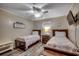Charming bedroom featuring two twin beds, a ceiling fan, and beach-themed decorations at 1582 S Waccamaw Dr. # 34, Garden City Beach, SC 29576