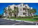 Three-story condo complex with balconies, palm trees and manicured landscaping at 1582 S Waccamaw Dr. # 34, Garden City Beach, SC 29576