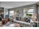 Cozy living room with comfortable striped couch and water views through bright windows at 1582 S Waccamaw Dr. # 34, Garden City Beach, SC 29576