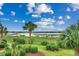 Scenic water view of the bay with community pier and lush foliage at 1582 S Waccamaw Dr. # 34, Garden City Beach, SC 29576