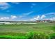 Scenic view with beautiful calm waters, lush green landscapes, and waterfront buildings in the distance at 1582 S Waccamaw Dr. # 34, Garden City Beach, SC 29576