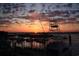 Sunset view of boats in a marina, silhouetted against a vibrant sky, and a nearby structure creating a beautiful scene at 1582 S Waccamaw Dr. # 34, Garden City Beach, SC 29576