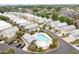 Aerial view of a community pool surrounded by numerous homes and lush landscaping at 1614 Cottage Cove Circle, North Myrtle Beach, SC 29582