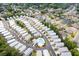 Expansive aerial view of a neighborhood with closely arranged houses and a central community pool at 1614 Cottage Cove Circle, North Myrtle Beach, SC 29582